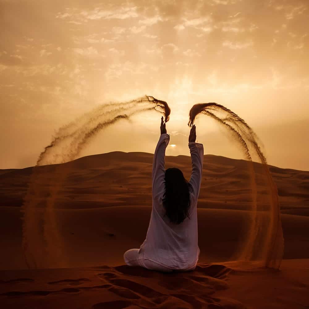 Woman throwing sand